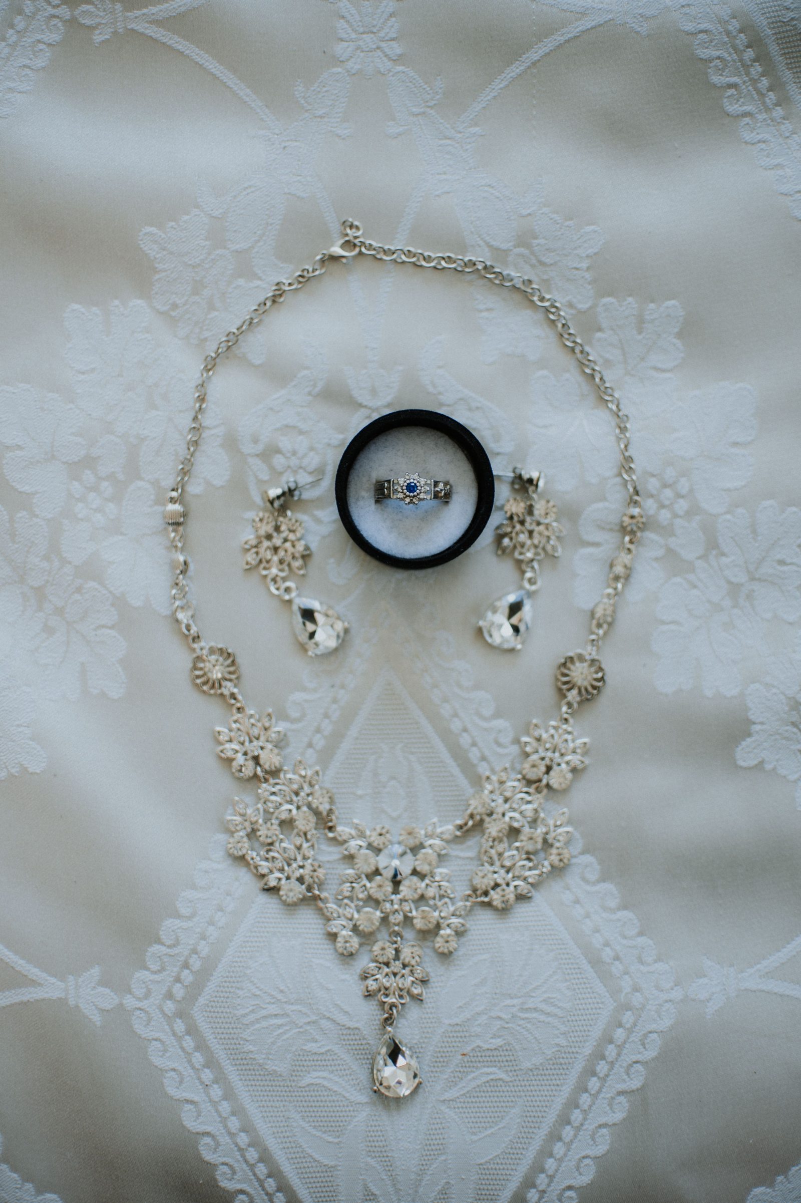 Bridal jewelry arranged on lace